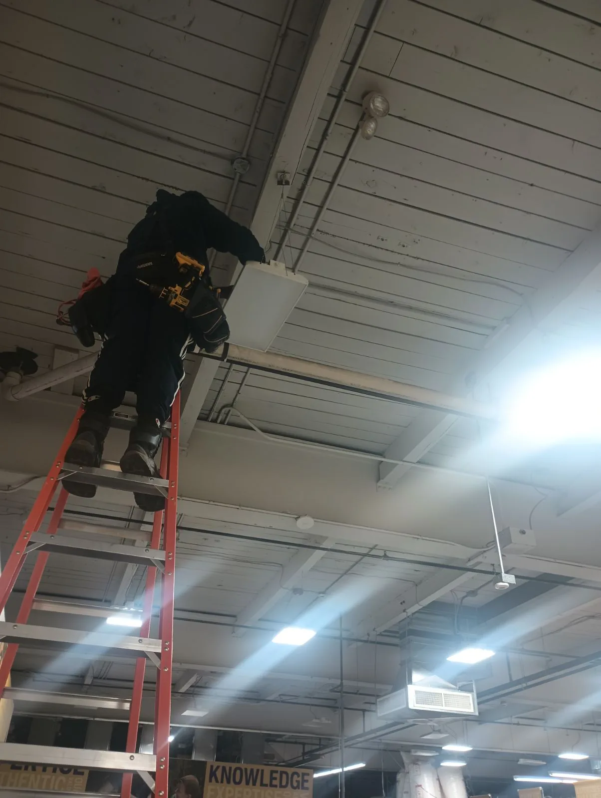 Berman Electric technician installing commercial ceiling electrical systems on Long Island